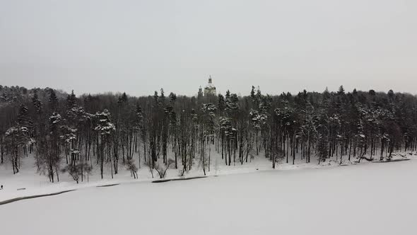 Drone raises behind from forest and reveals Pazaislis Monastery in Kaunas alt