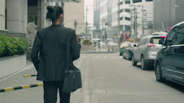 Asian businessman casual dress holding coffee cup during walking in the street.