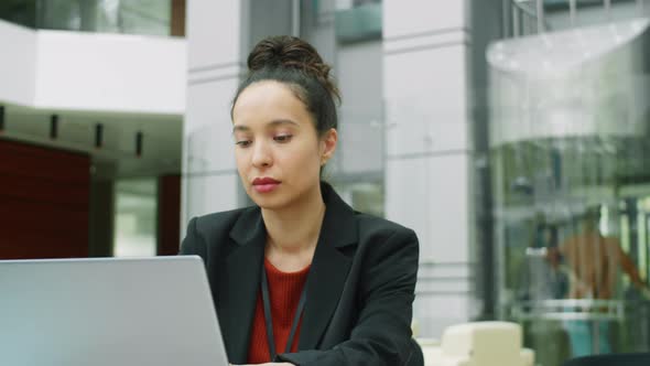 Businesswoman Working on Laptop in Office Center alt