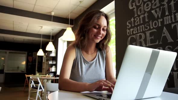 Slow Motion Young Smiling Woman Making Video Call By Laptop at Cafe.