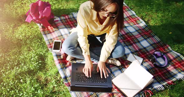 Female Student Studying in Park Top View