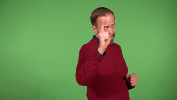 A Middleaged Handsome Caucasian Man Points at the Camera and Nods  Green Screen Background