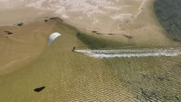 Beautiful Aerial Drone Shot of Kitesurfer Doing Tricks on a Crystal Clear Lagoon in Hermanus South A alt