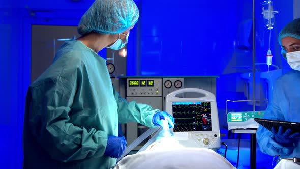 Female Medics Performing Surgery in Operating Theater