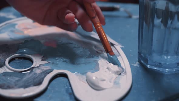Artist Mixes Paints