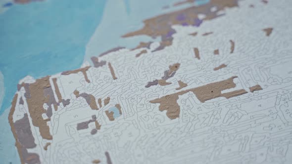 Female Hands Hold a Paintbrush and Fill the Painting with Numbers with Color alt