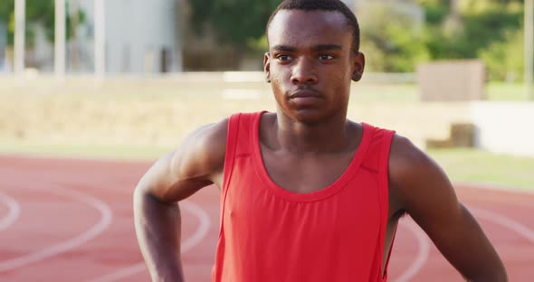 Disabled mixed race man with prosthetic legs focusing before a race alt