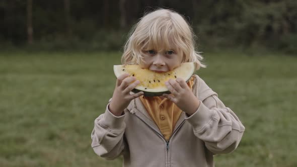 Blond Boy Eating Yellow Watermelon alt