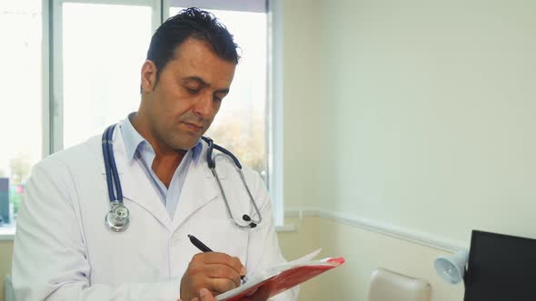 Smart Doctor Makes Notes in His Notebook