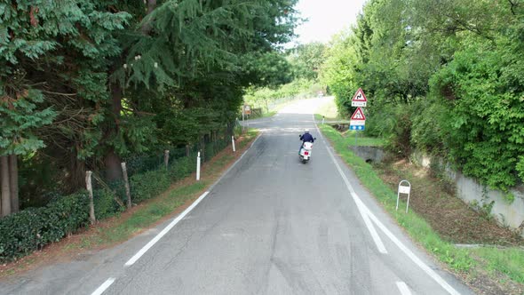 Group of Bikers on Mopeds Ride Along the Italian Road Aerial View alt