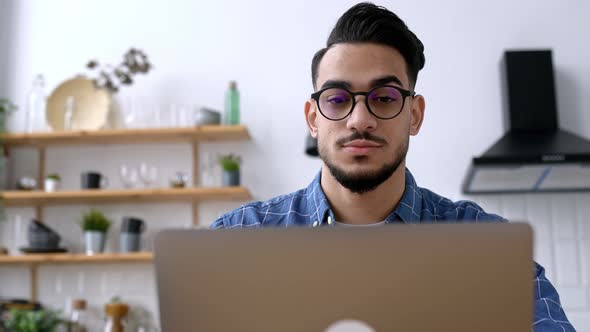 Closeup of an Attractive Positive Indian or Arabian Guy with Glasses Freelancer or Creative Designer alt