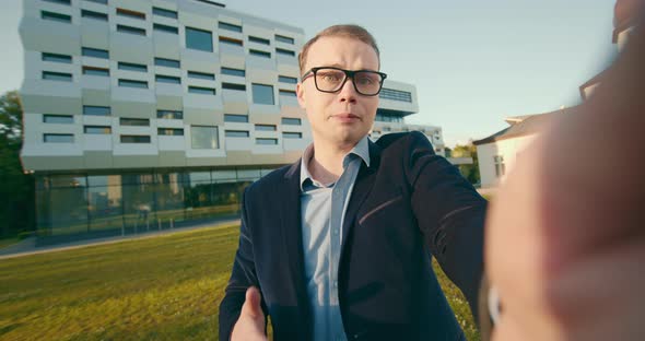 A Businessman is Emotionally Talking Through a Video Link on a Smartphone alt