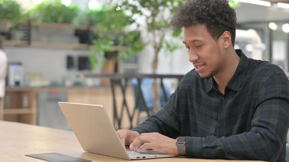 African American Man with Laptop Having Wrist Pain alt