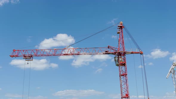 High industrial tower crane at construction site of new residential building. Time lapse alt