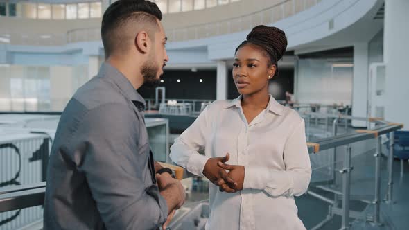 African American Woman and Arabian Indian Businessman Talking in Loft Office Hall Working Break alt