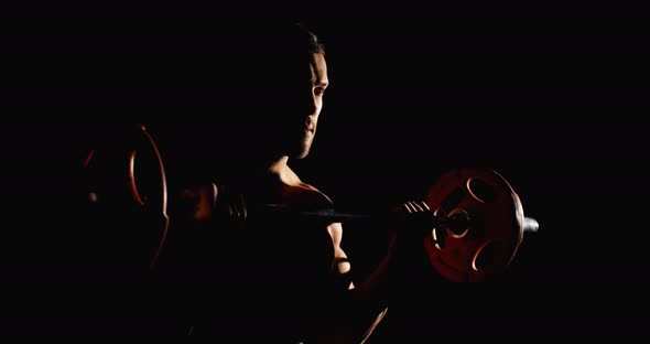 Athletic Man Doing Training In Gym Lifting A Barbell Black Background alt