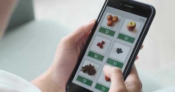 Ordering Food Vegetables and Fruits Online Using Smartphone App Close Up alt