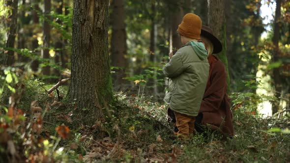 Mother and son are in autumn season forest