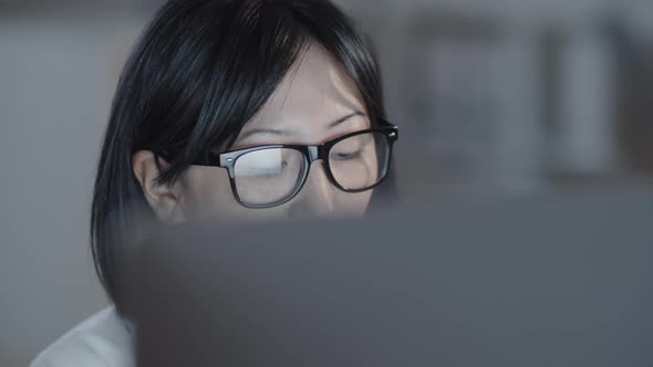 Beautiful Woman Working on Computer in Evening alt