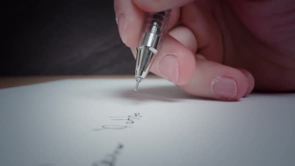 Man Writes with Black Pen on White Clean Page Lying on Table alt