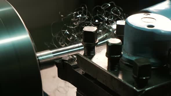 Turning Lathe in Action. Cutter Removes Metal Shavings From the Steel Billet, Close-up. Metal alt