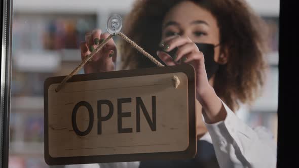 Young Woman Restaurant Owner in Protective Mask Turns Sign That Says CLOSED Tired Female Waiter alt