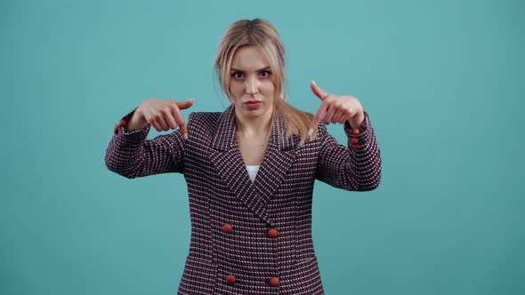 The Portrait of a Charismatic Girl Who Shocked Points with Her Index Fingers Down and Says Look alt