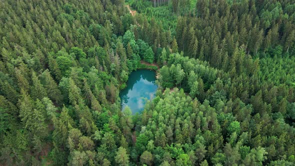 Aerial View of Blue Colored Forest Lake in Poland alt