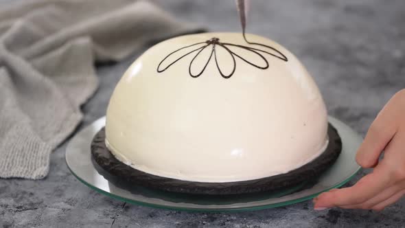 Pouring melted chocolate on top of a cake. Pancho cake with pineapple and sour cream alt