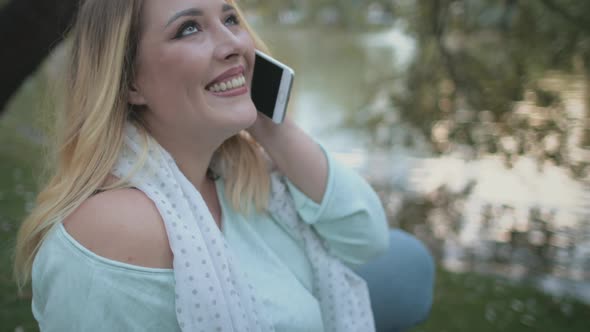 Blonde Woman Plus Size Talk Smartphone Sit By Lake