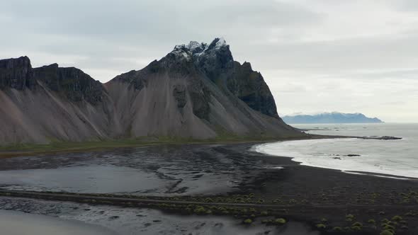 Drone Panning Over Black Sand Beach And Vestrahorn Mountain alt