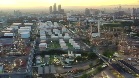 4k aerial view drone of refinery oil petroleum production factory with river reflecting surface sunr alt
