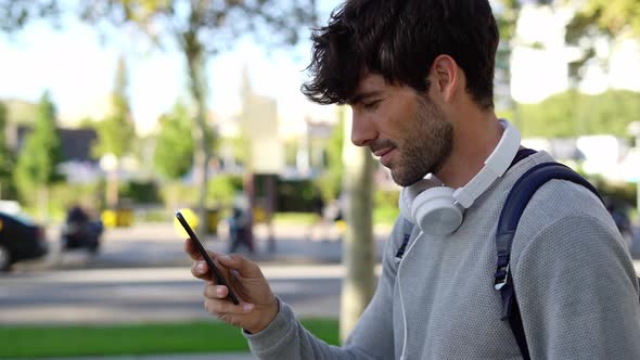 Man with backpack and smartphone in the city alt