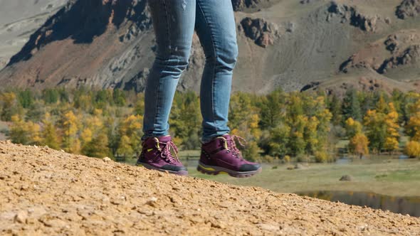 Closeup of Woman Traveler Hiking in the Mountains alt