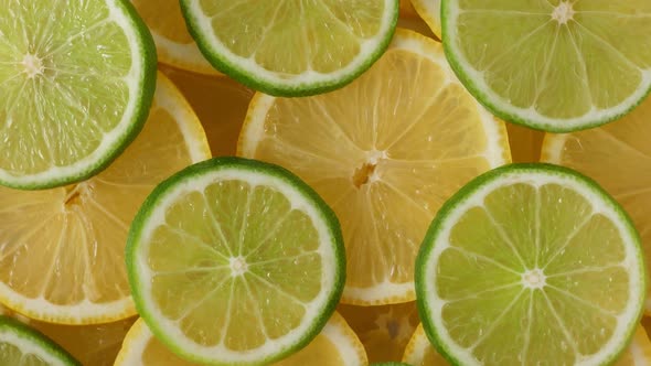 Lemon Slices with One Cut Lime Slice Closeup, Macro Food Summer Background alt