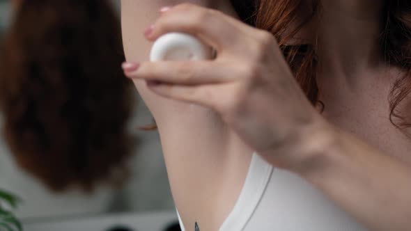 Close up of woman with applying antiperspirant. Shot with RED helium camera in 4K. alt