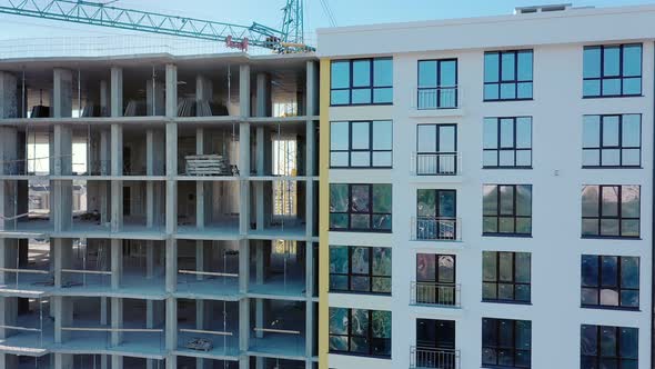 Many windows on new apartment building facade under construction. Real estate development alt