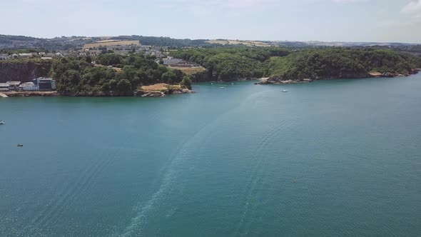 Flying towards the beach of Brixham in England. Beach cove in southwest England. alt