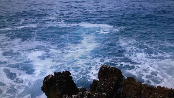 Sea Waves and Black Rocks