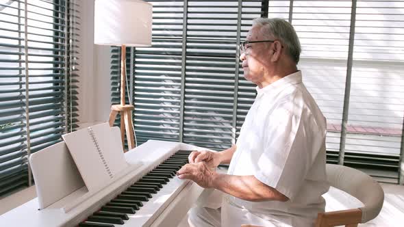 Middle-aged male enjoying a unique moment while playing the piano. alt