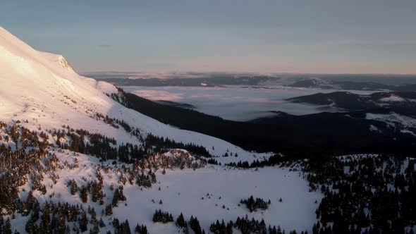 Aerial View of Mountain Valley With Sea of Clouds at Sunrise