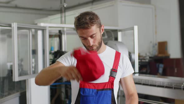 Portrait of a Young Caucasian Worker in a Warehouse or Factory