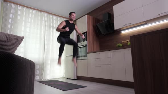 A Man Performs an Endurance Exercise in a Home Environment