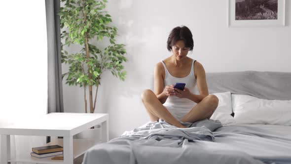 Woman with Smartphone in Morning