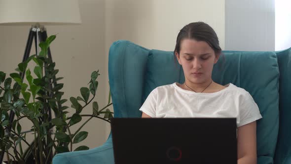 Authentic Young Woman Chatting On Laptop In Living Room