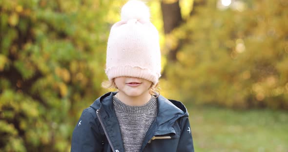 Little Kid Playing in Beautiful Sunny but Cold Day Outside.