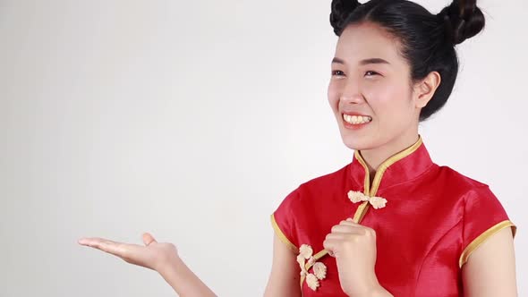 woman wear red cheongsam with open hand palm in concept of happy chinese new year alt