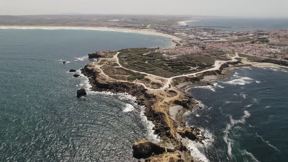 Aerial of rocky peninsula with cliffs in Peniche, Portugal