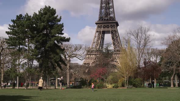 Eiffel Tower with trees in the foreground. alt