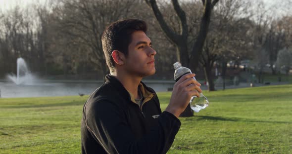 Healthy Young Man Drinking Water From the Bottle Outdoors 11B